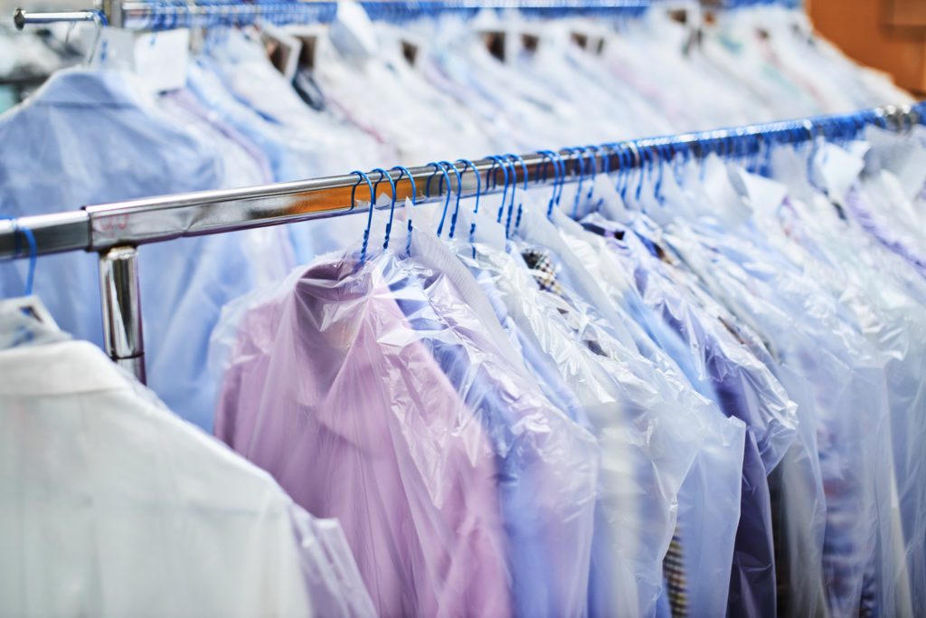 Clean garments hanging in protective bags